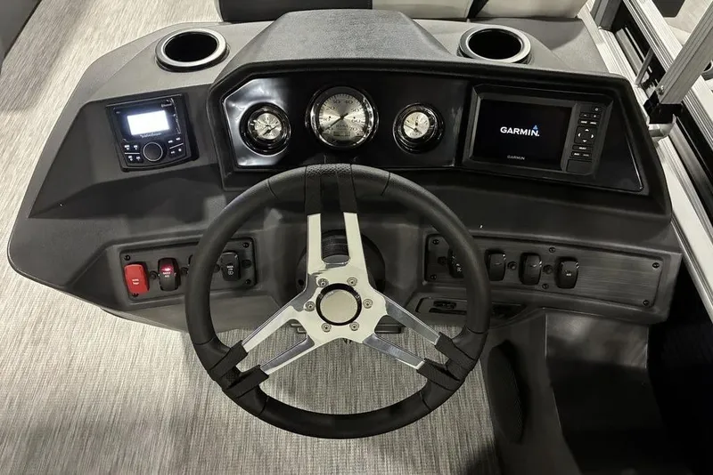 Slide: The Image of 2025 Bennington S L-Bench 20 SL boat dashboard with Garmin display and controls. - 6