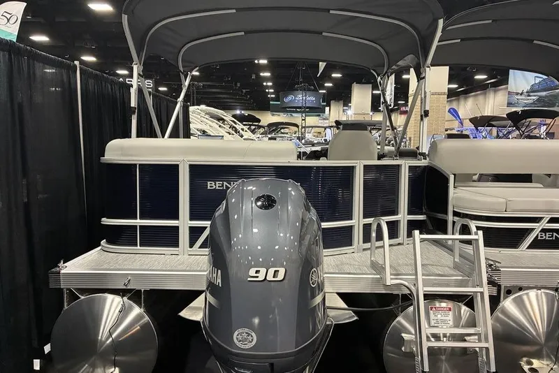 Slide: The Image of 2025 Bennington S L-Bench 20 SL pontoon boat with Yamaha 90 engine at a boat show. - 7
