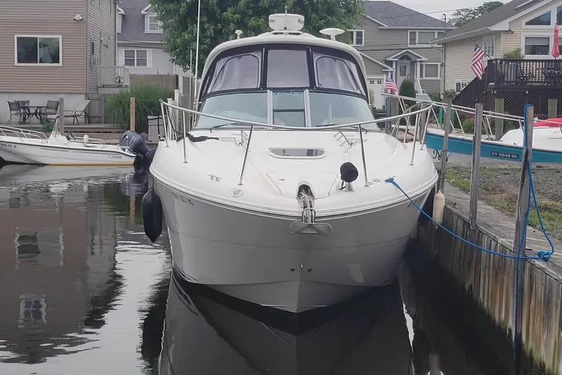 Slide: The Image of 2008 Sea Ray Sundancer 330 docked in a residential marina setting. - 2