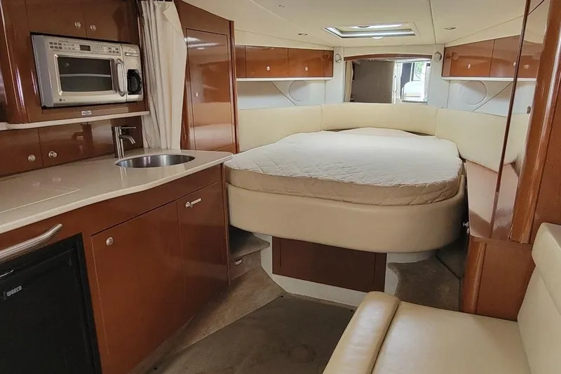 Slide: The Image of Interior of 2008 Sea Ray Sundancer 330 with kitchenette and cozy sleeping area. - 9