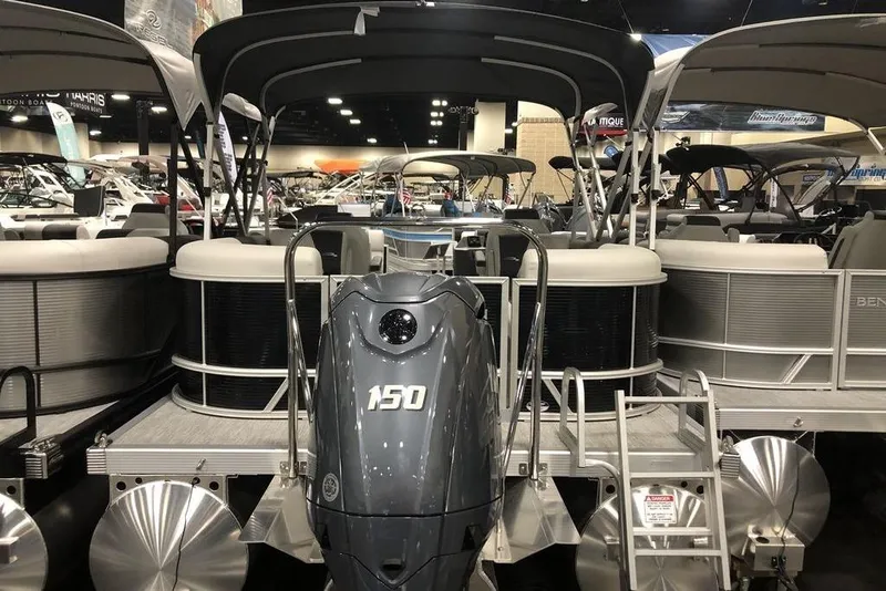 Slide: The Image of 2026 Bennington S Quad Bench 22 SSR SPS pontoon boat with 150 HP engine at a boat show. - 6