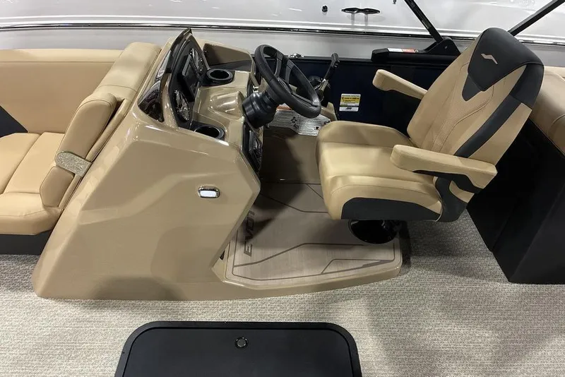 Slide: The Image of Captain's seat and console of 2026 Evotti 521QL boat, featuring beige and black upholstery. - 3