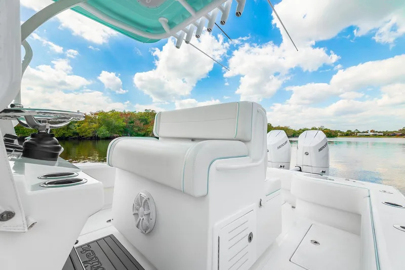 Slide: The Image of 2024 SeaHunter 28 Floridian boat interior with seating, water view, and clear sky. - 12