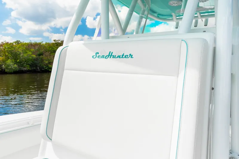 Slide: The Image of 2024 SeaHunter 28 Floridian boat seat with logo, set against a scenic water backdrop. - 9