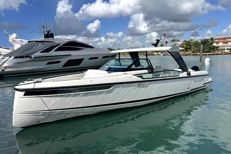 The Image of 2025 Saxdor 320 GTO boat docked in a marina under a blue sky. - 1