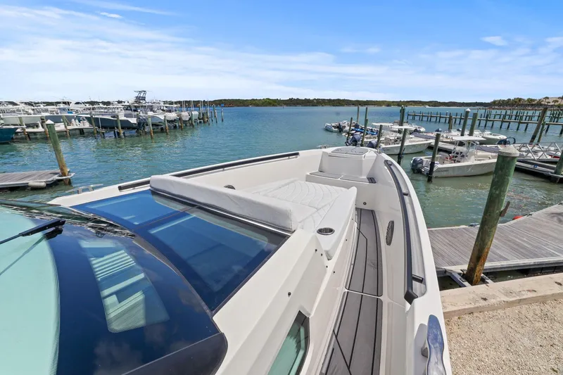 Slide: The Image of 2025 Saxdor 320 GTO docked at a marina, showcasing sleek design and spacious deck. - 10