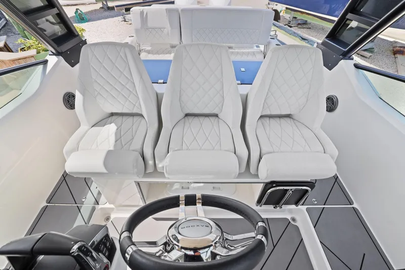 Slide: The Image of 2025 Saxdor 320 GTO cockpit with three white quilted seats and modern steering wheel. - 16