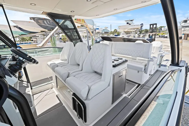Slide: The Image of 2025 Saxdor 320 GTO boat interior with luxurious white seating and modern design. - 19