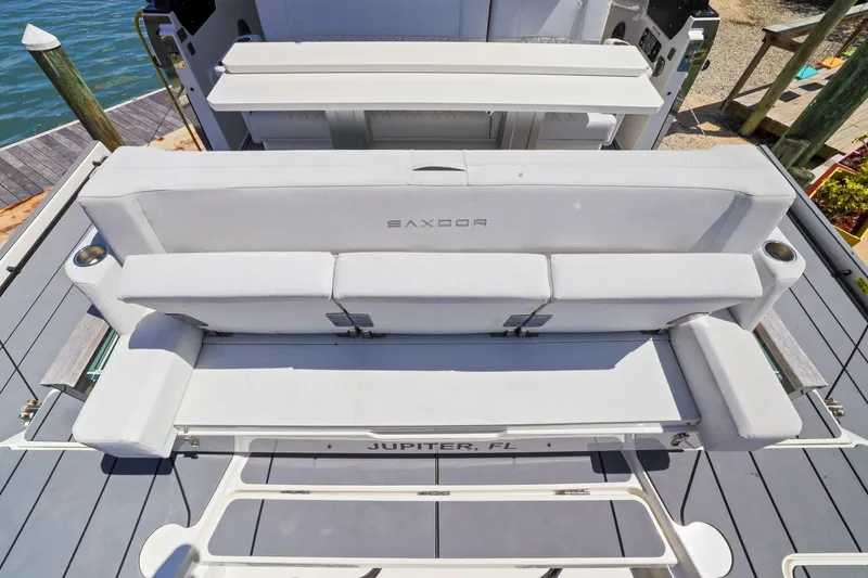 Slide: The Image of 2025 Saxdor 320 GTO boat seating area with sleek design and cup holders. - 24