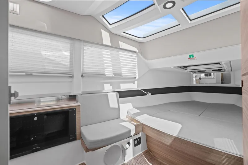 Slide: The Image of Interior of 2025 Saxdor 320 GTO boat, featuring modern seating and skylights. - 31