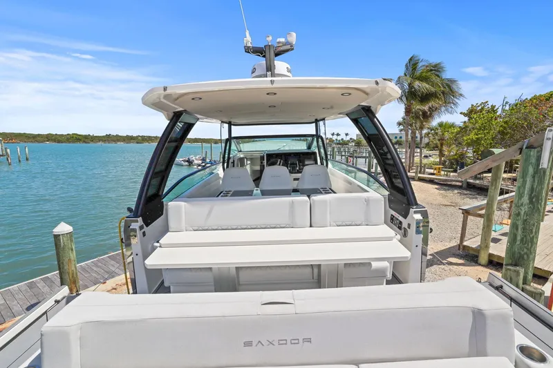 Slide: The Image of 2025 Saxdor 320 GTO luxury boat docked by a scenic waterfront. - 37