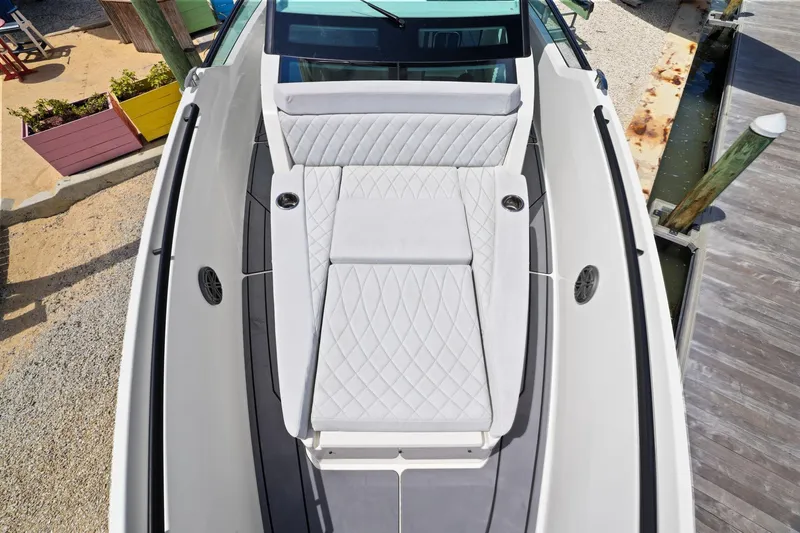 Slide: The Image of 2025 Saxdor 320 GTO boat with luxurious white seating and modern design at dockside. - 39
