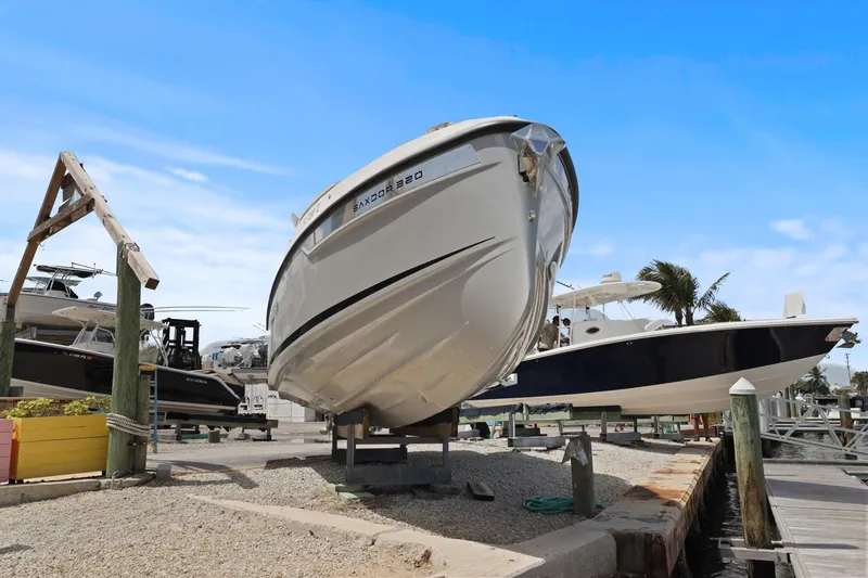 Slide: The Image of 2025 Saxdor 320 GTO boat displayed on a dock under a clear blue sky. - 4
