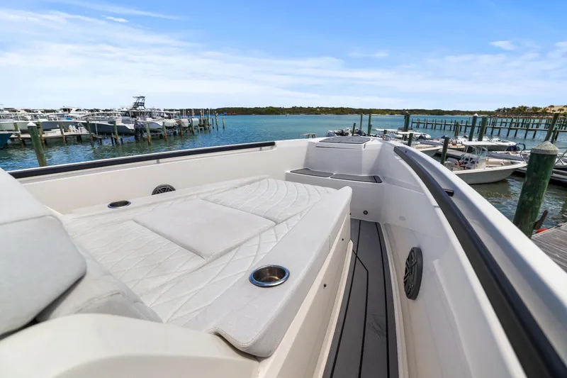 Slide: The Image of 2025 Saxdor 320 GTO boat docked at a marina, featuring a spacious deck. - 41