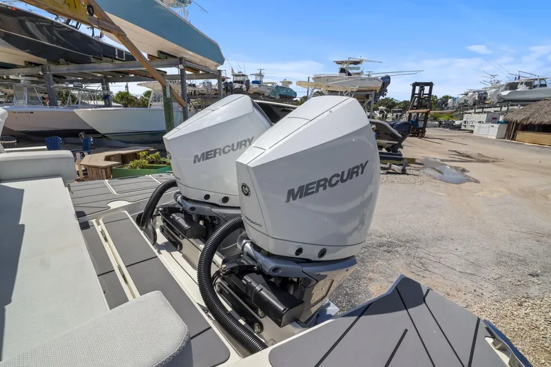 Slide: The Image of Twin Mercury outboard engines on a 2025 Saxdor 320 GTO boat in a marina setting. - 44