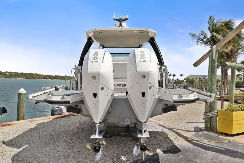 Slide: The Image of 2025 Saxdor 320 GTO boat with dual 300 V8 engines docked by the water. - 7