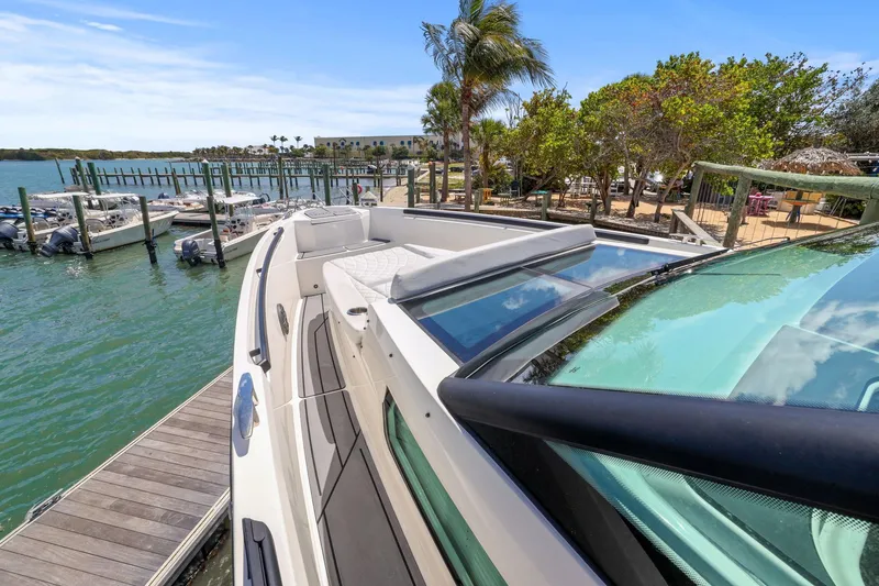 Slide: The Image of 2025 Saxdor 320 GTO yacht docked at a scenic marina with clear skies. - 8