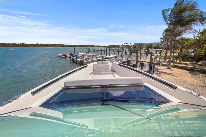 Slide: The Image of Saxdor 320 GTO 2025 yacht docked at a scenic marina with palm trees. - 9