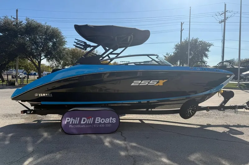 Slide: The Image of 2023 Yamaha Boats 255XD in blue and black on display at Phil Dill Boats. - 4
