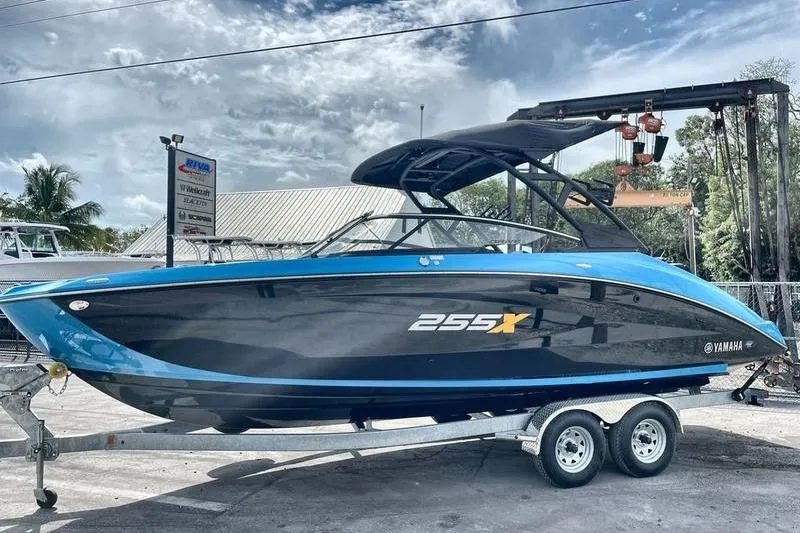 Slide: The Image of 2023 Yamaha Boats 255XD on trailer, sleek design, blue and black color scheme. - 9