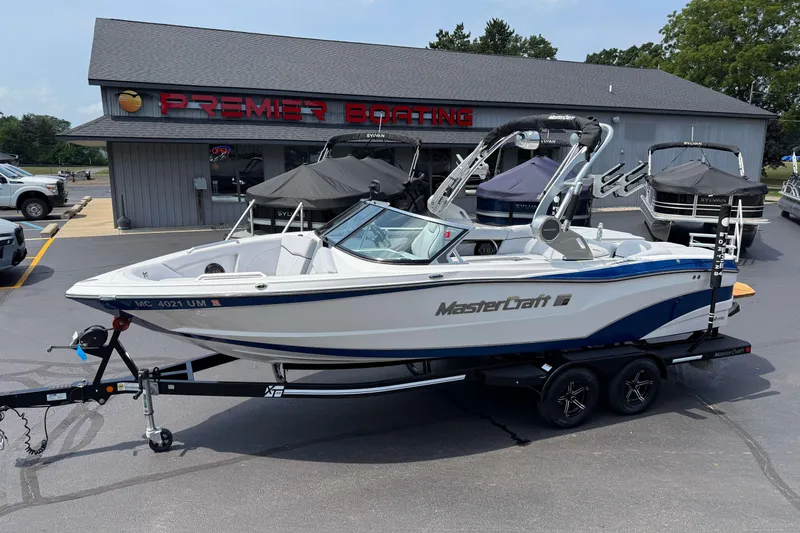 The Image of 2020 MasterCraft XT23 boat on trailer at Premier Boating dealership. - 0