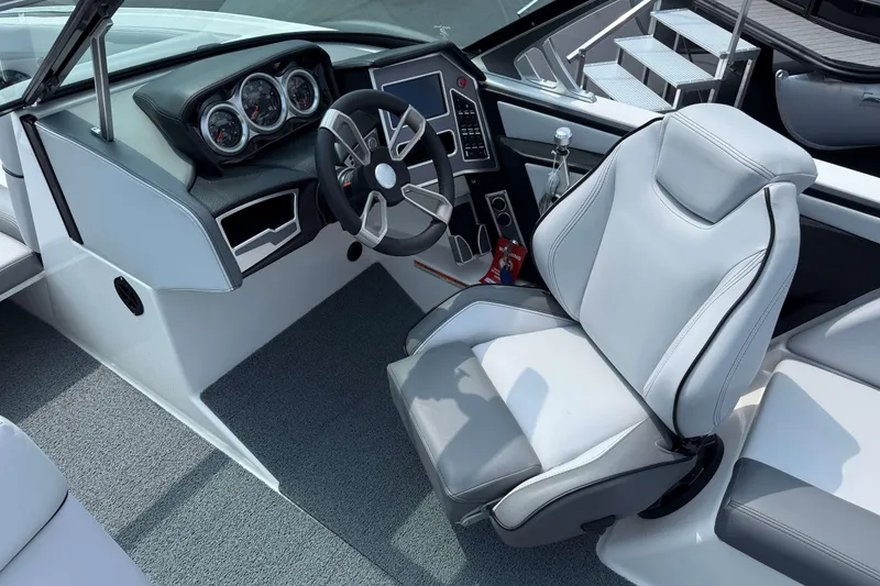 Slide: The Image of 2020 MasterCraft XT23 boat cockpit with modern steering and controls. - 11