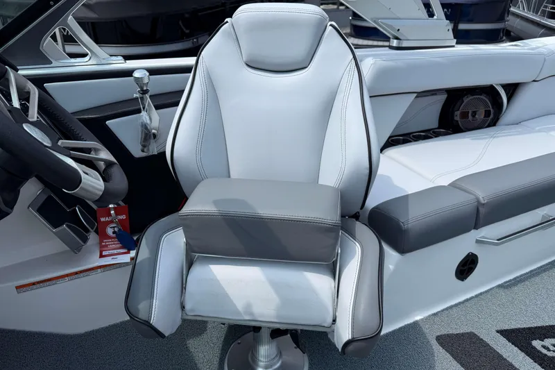 Slide: The Image of 2020 MasterCraft XT23 boat interior with gray and white captain's chair. - 12
