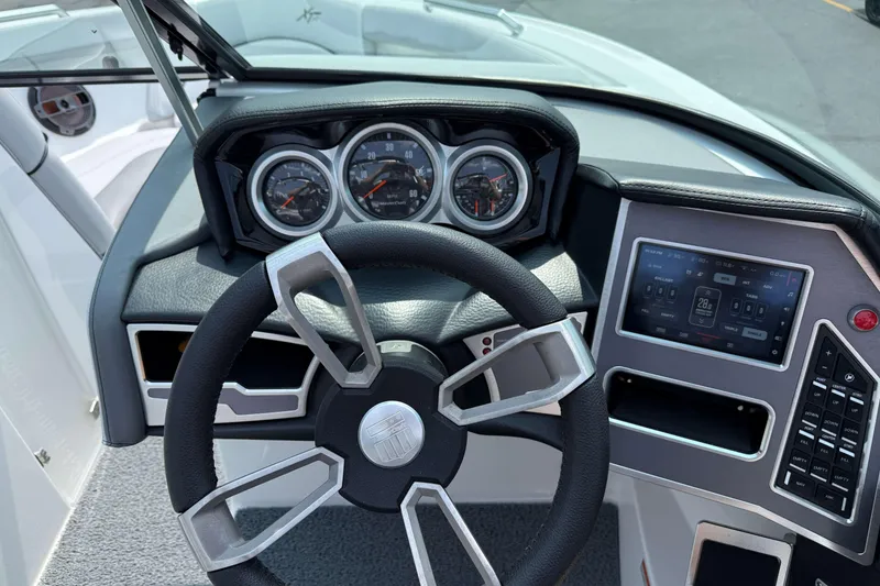 Slide: The Image of 2020 MasterCraft XT23 dashboard with steering wheel and digital display. - 13