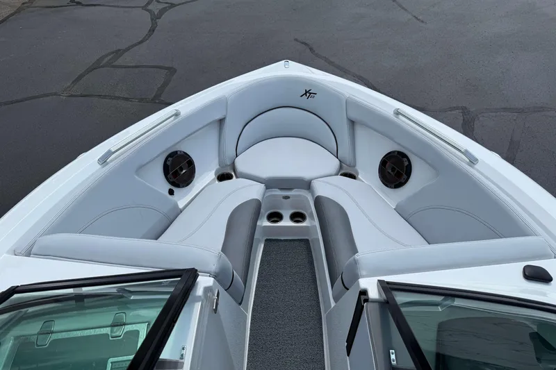 Slide: The Image of 2020 MasterCraft XT23 boat interior with white seating and speakers. - 16