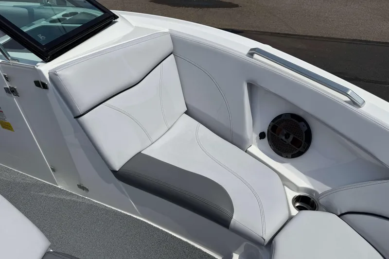 Slide: The Image of 2020 MasterCraft XT23 boat interior with white cushioned seating and speaker. - 17