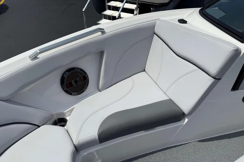 Slide: The Image of 2020 MasterCraft XT23 boat interior with white cushioned seating and speaker detail. - 18