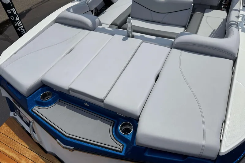 Slide: The Image of 2020 MasterCraft XT23 boat with spacious, cushioned seating and cup holders. - 3