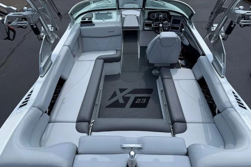 Slide: The Image of 2020 MasterCraft XT23 boat interior with sleek seating and modern dashboard design. - 4