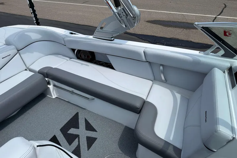 Slide: The Image of 2020 MasterCraft XT23 boat interior with sleek white and gray seating. - 7