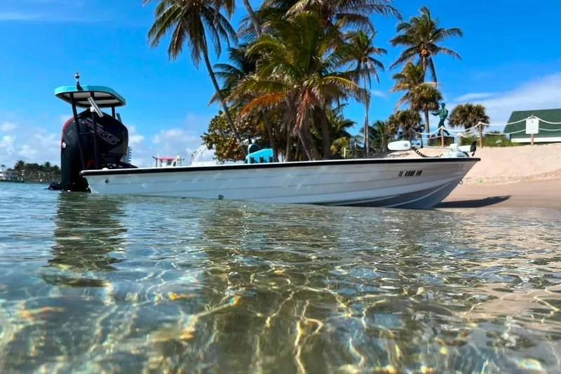 Slide: The Image of 1994 Hewes Redfisher 18 boat on tropical beach with clear water and palm trees. - 3