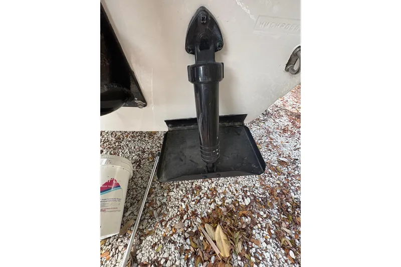 Slide: The Image of 1994 Hewes Redfisher 18 boat detail with black transom and gravel ground. - 8