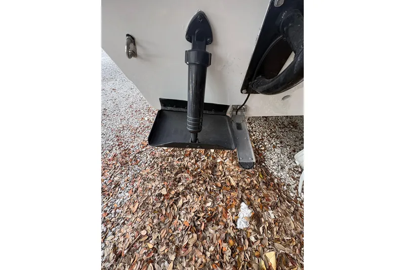 Slide: The Image of 1994 Hewes Redfisher 18 boat detail with trim tab and fallen leaves. - 9