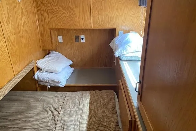 Slide: The Image of Cozy bedroom in 2005 Sumerset Starchaser houseboat with wooden interior and bed. - 10