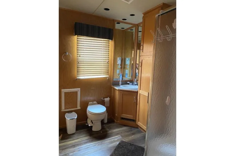 Slide: The Image of Bathroom in 2005 Sumerset Starchaser houseboat, featuring wood cabinetry and modern fixtures. - 11