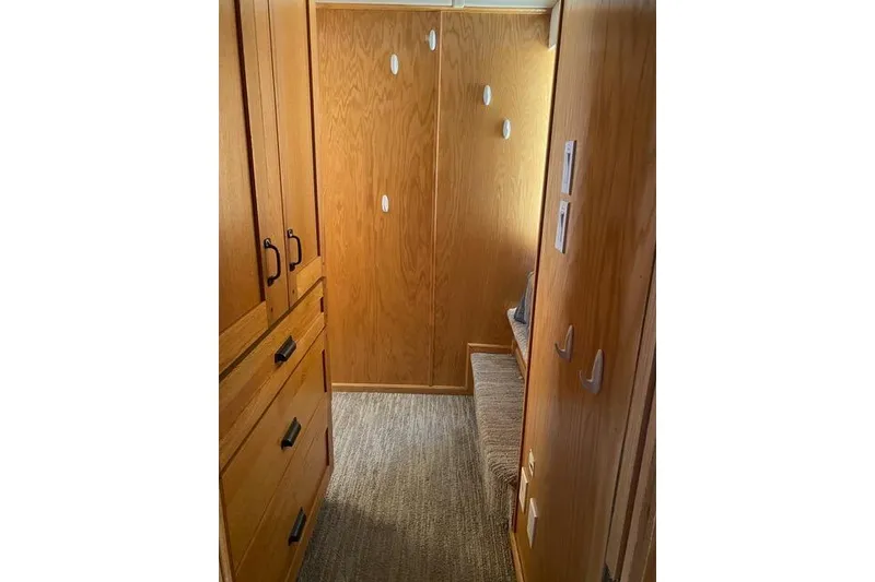 Slide: The Image of Interior of 2005 Sumerset Starchaser, featuring wooden cabinetry and carpeted flooring. - 12