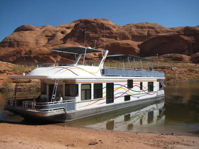 Slide: The Image of 2005 Sumerset Starchaser houseboat against rocky backdrop. - 3