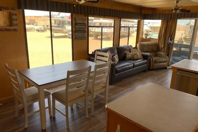 Slide: The Image of Interior of 2005 Sumerset Starchaser houseboat with dining area and comfortable seating. - 4