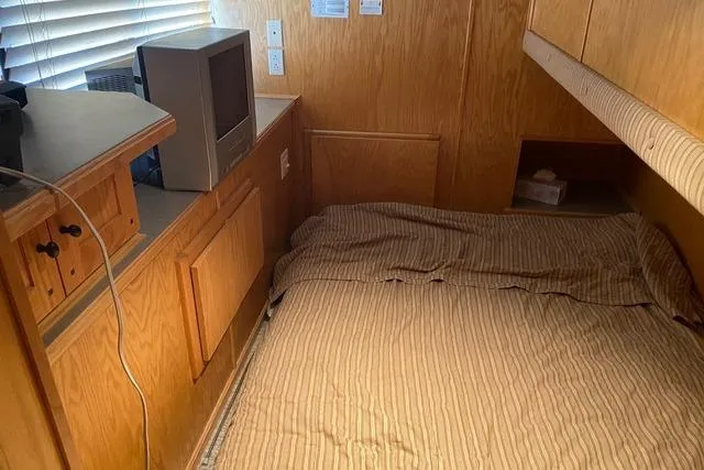 Slide: The Image of Cozy interior of 2005 Sumerset Starchaser houseboat with bed and TV. - 8