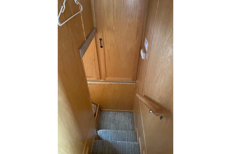 Slide: The Image of Staircase in 2005 Sumerset Starchaser houseboat with wooden paneling and carpeted steps. - 9
