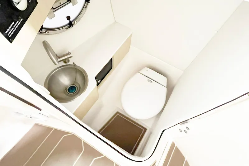 Slide: The Image of Compact bathroom in 2025 Regal LX6 boat with sink and toilet. - 12
