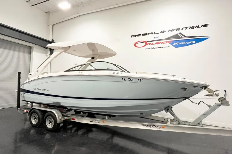 Slide: The Image of 2025 Regal LX6 boat on trailer in showroom, side view. - 3