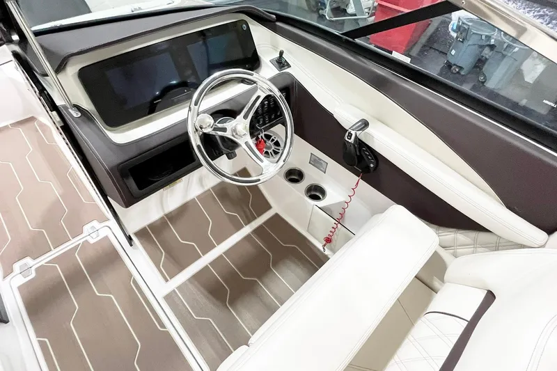 Slide: The Image of 2025 Regal LX6 boat interior with modern steering wheel and sleek dashboard design. - 9