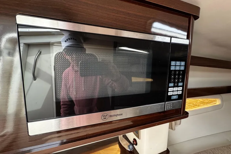 Slide: The Image of Microwave in 2016 Sea Ray Sundancer 260 cabin, featuring sleek design and modern controls. - 13