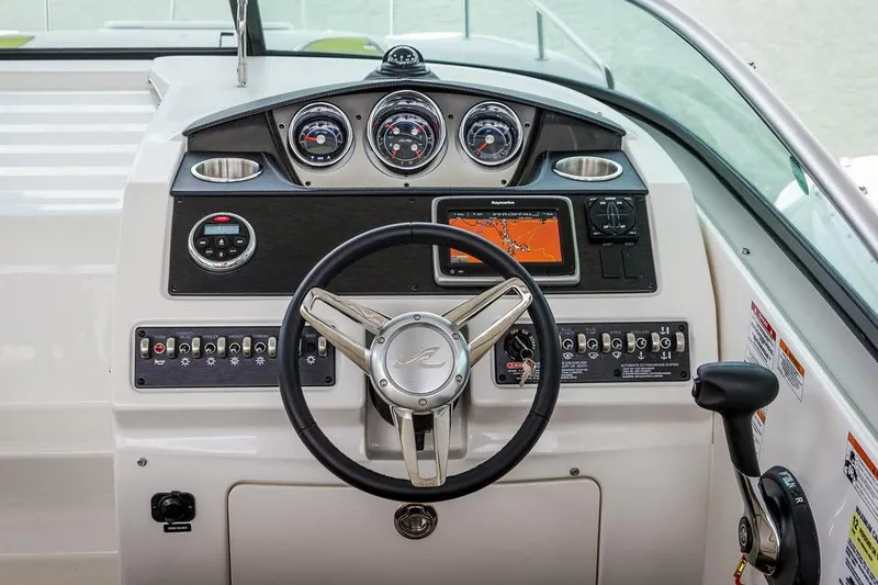 Slide: The Image of Manufacturer Provided Image: 2016 Sea Ray 260 Sundancer boat dashboard with steering wheel and navigation controls. - 4