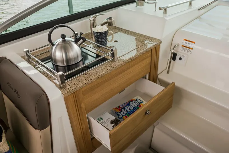 Slide: The Image of Manufacturer Provided Image: Sea Ray 260 Sundancer 2016 interior galley with kettle, mug, and drawer storage. - 5